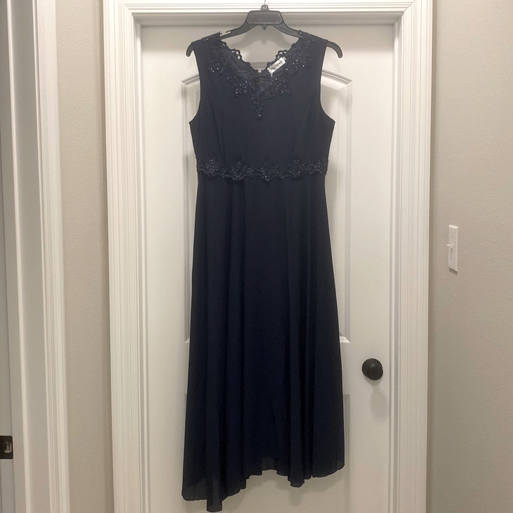Brand New.  Navy Blue sleeveless dress with a sleeved matching jacket.